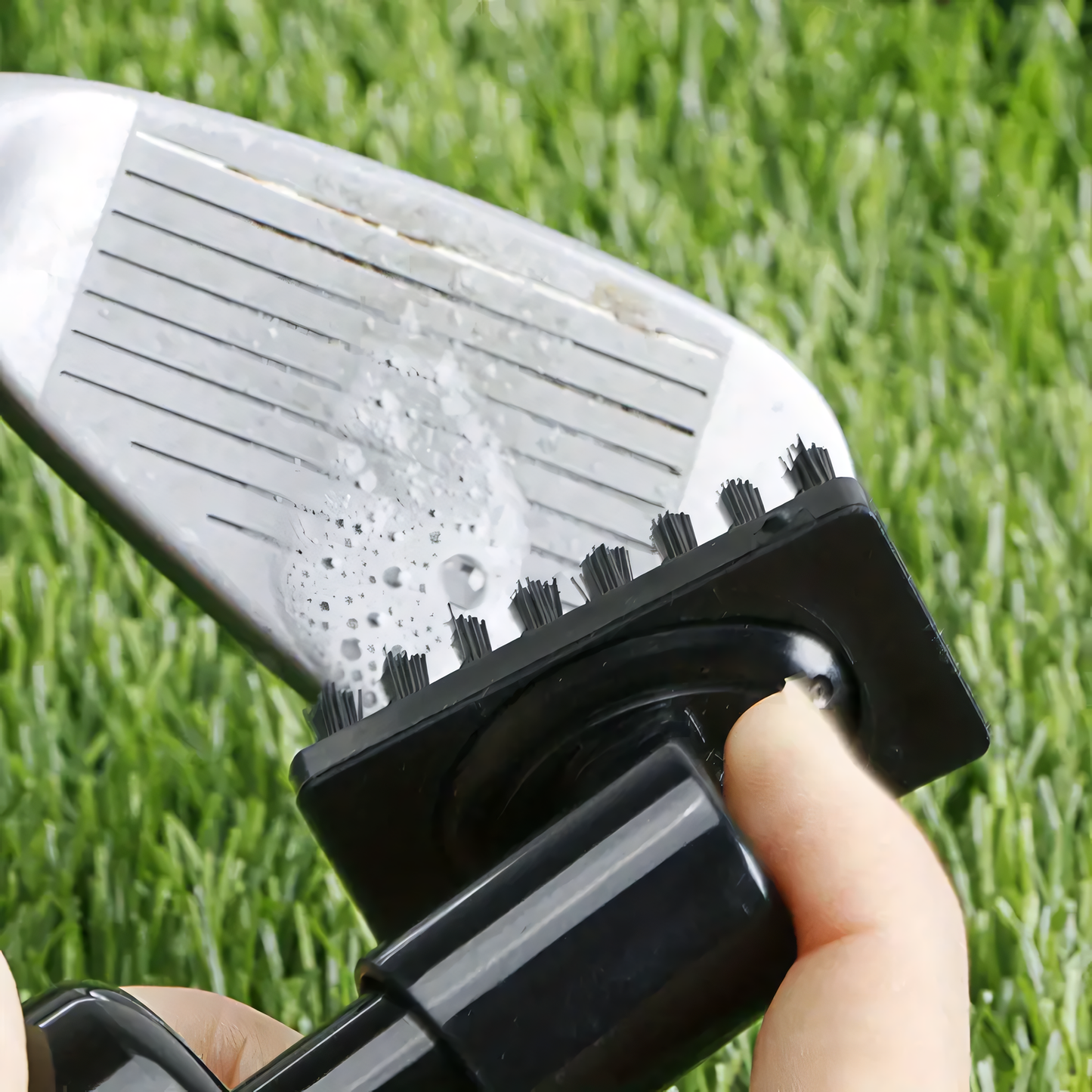 Golfer using best portable golf club cleaning brush on the green to enhance club performance.